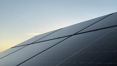 time lapse at sunset of solar panel photovoltaic system for green energy supply production