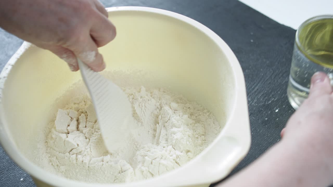 Female hands sifts the flour