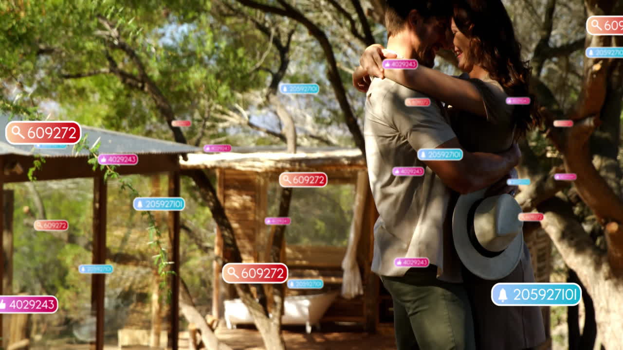 Couple hugging in outdoor glamping retreat, displaying floating digital marketing data tags