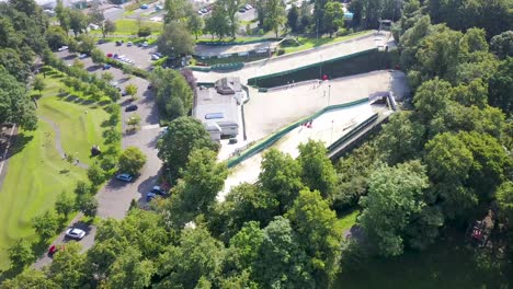 Drone-rotating-around-a-dry-ski-slope-in-a-park