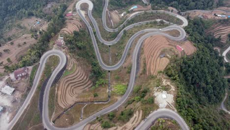 straight down aerial view of traffic on the bp highway, bardibas highway, showing the switchbacks and turns as it winds through the hills of nepal