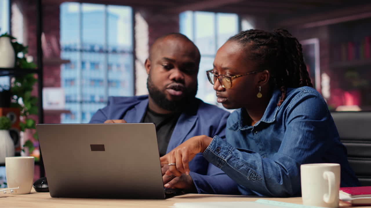 Black freelancers team at home desk using laptop and checking emails