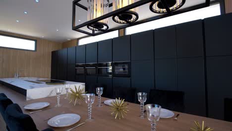 slow establishing shot of a preset kitchen table ready for a meal