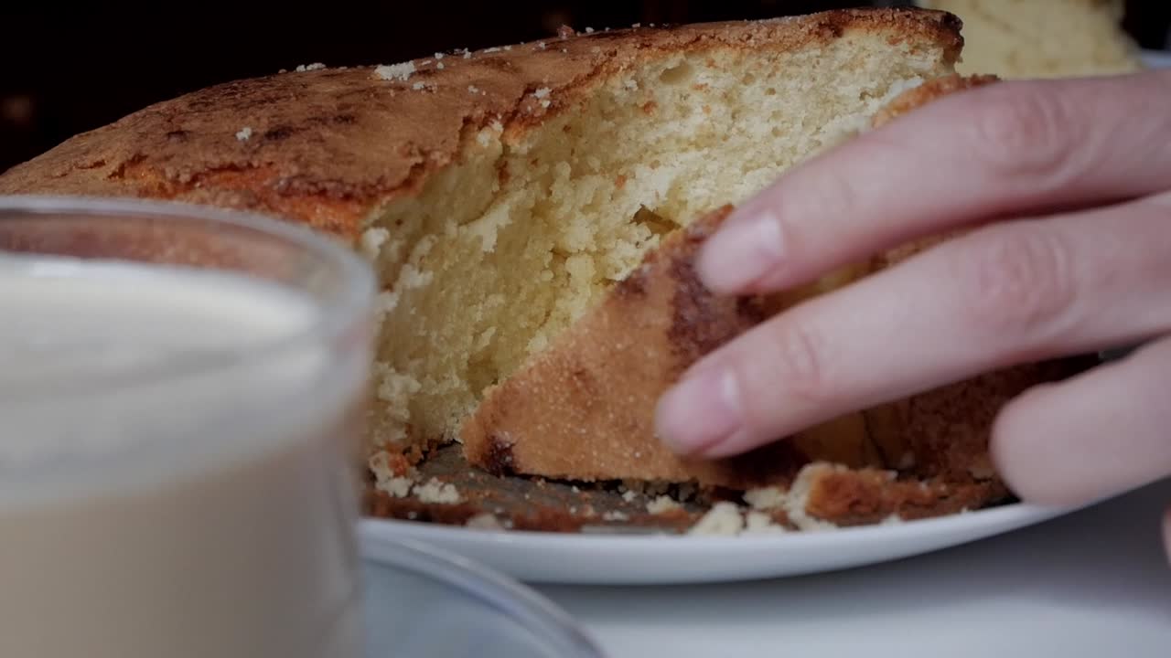 Freshly sliced sponge cake with latte coffee beside it, cozy indulgence moment
