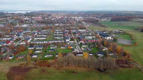 rising aerial drone above western sweden suburb houses on overcast day