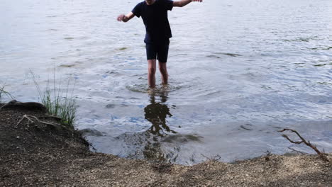 boy walking into a lake