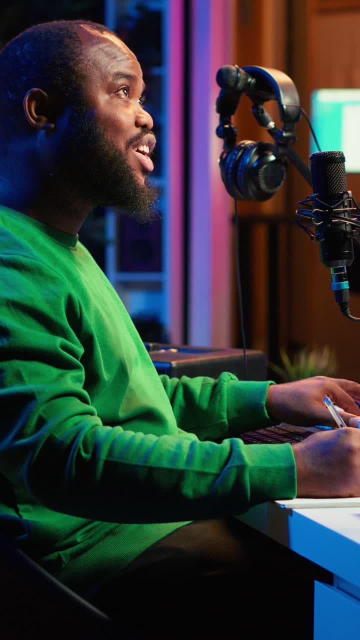 African American Man Composing Music and Talking in Studio