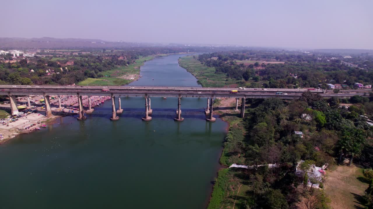 aerial view of Narmada River with Tilwara bridge and greenery at day time, push in, pan shot, drone shot, 4k.