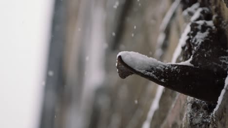 close up of building with falling snow