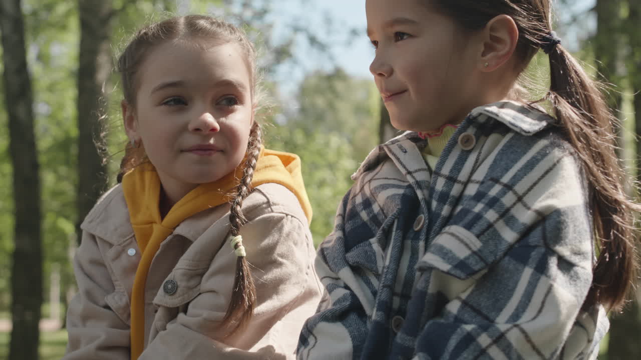 Two Little Girls Chatting Outdoors