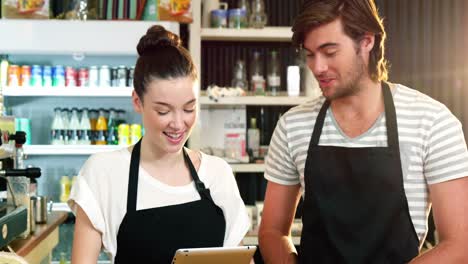 waiter and waitress using digital tablet