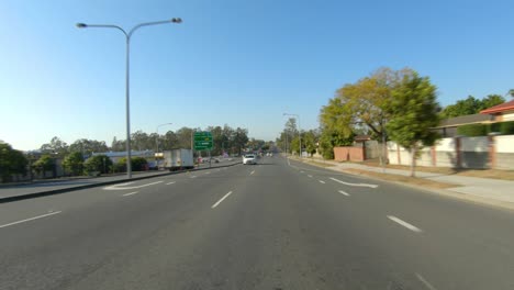 rear facing driving point of view pov of quiet australian suburban freeway - ideal for interior car scene green screen replacement