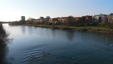 wonderful view of bridge over ticino river in pavia city at sunset, background urban skyline,lombardy, italy