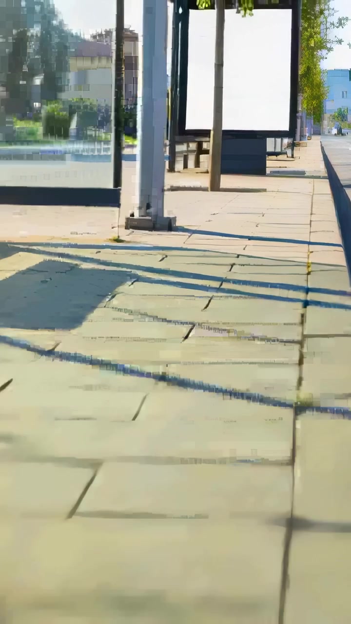 Vertical video: Moving camera revealing tiled sidewalk, bus shelter and blank ad panels on street