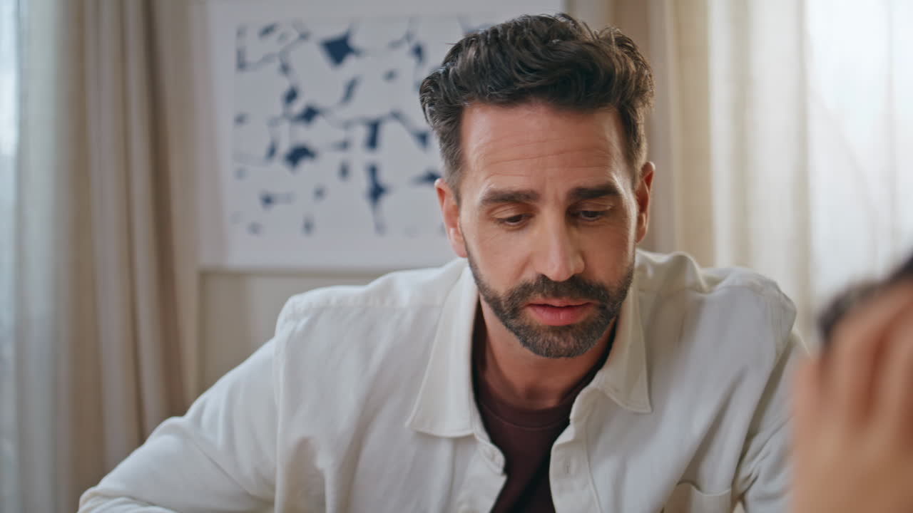 Bearded man talking son at living room closeup. Positive daddy doing homework