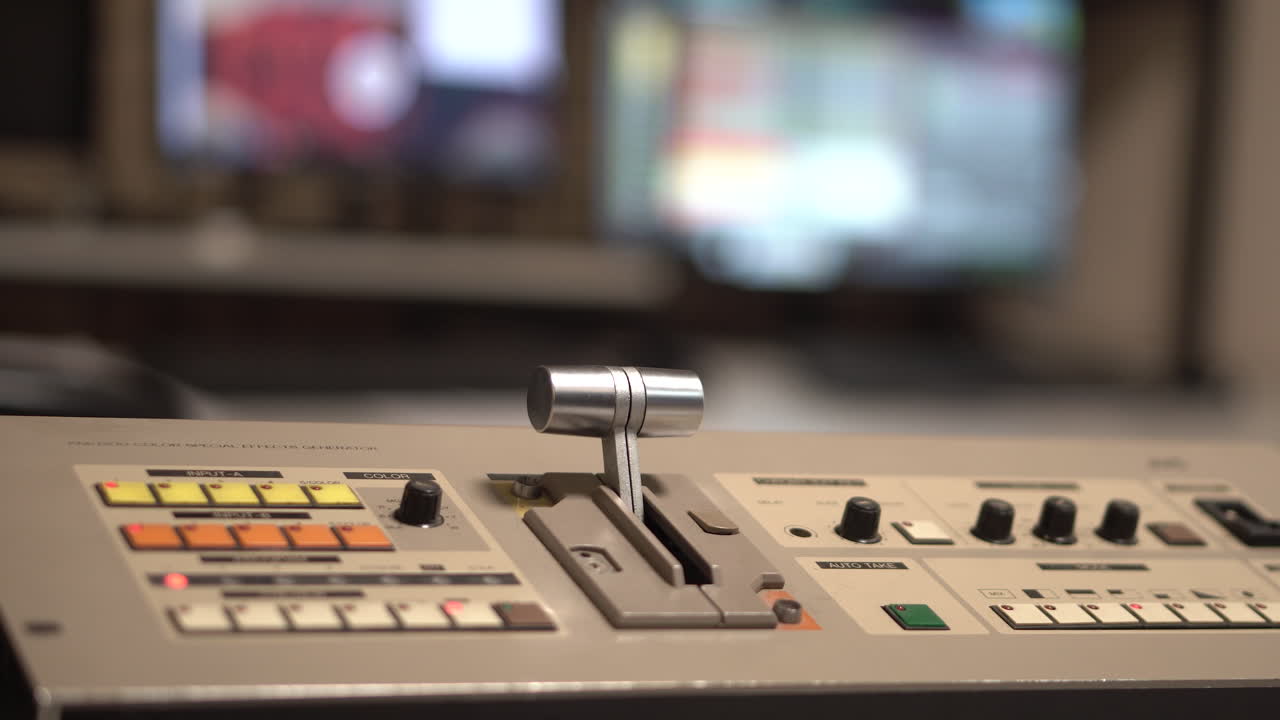 Hand on Analogue Television Switcher Mixer in Control Room of TV Station From 1990's