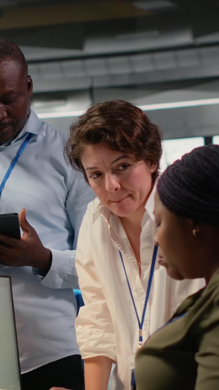 Vertical video Team of software developers in office working together, automating using AI