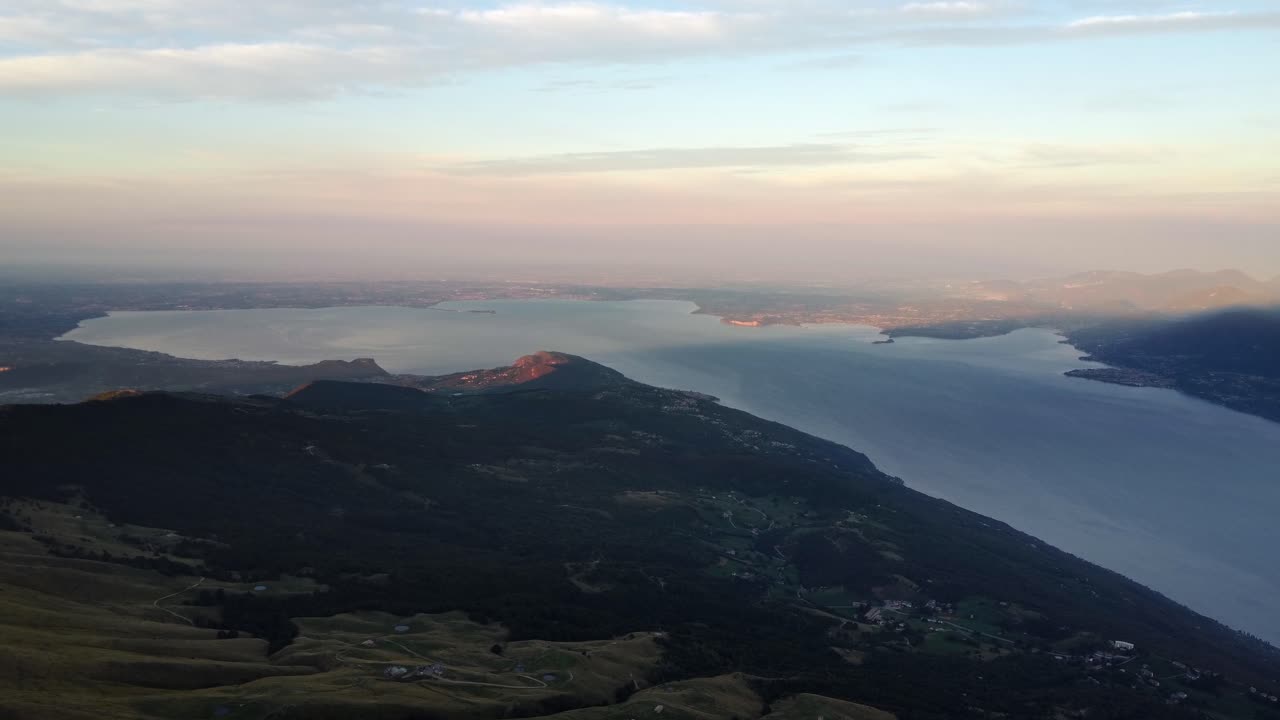 A sweeping aerial perspective of Lake Garda seen from Monte Baldo. This bird’s-eye view captures the lake’s vast shoreline, surrounding hills, and the alpine beauty of northern Italy.