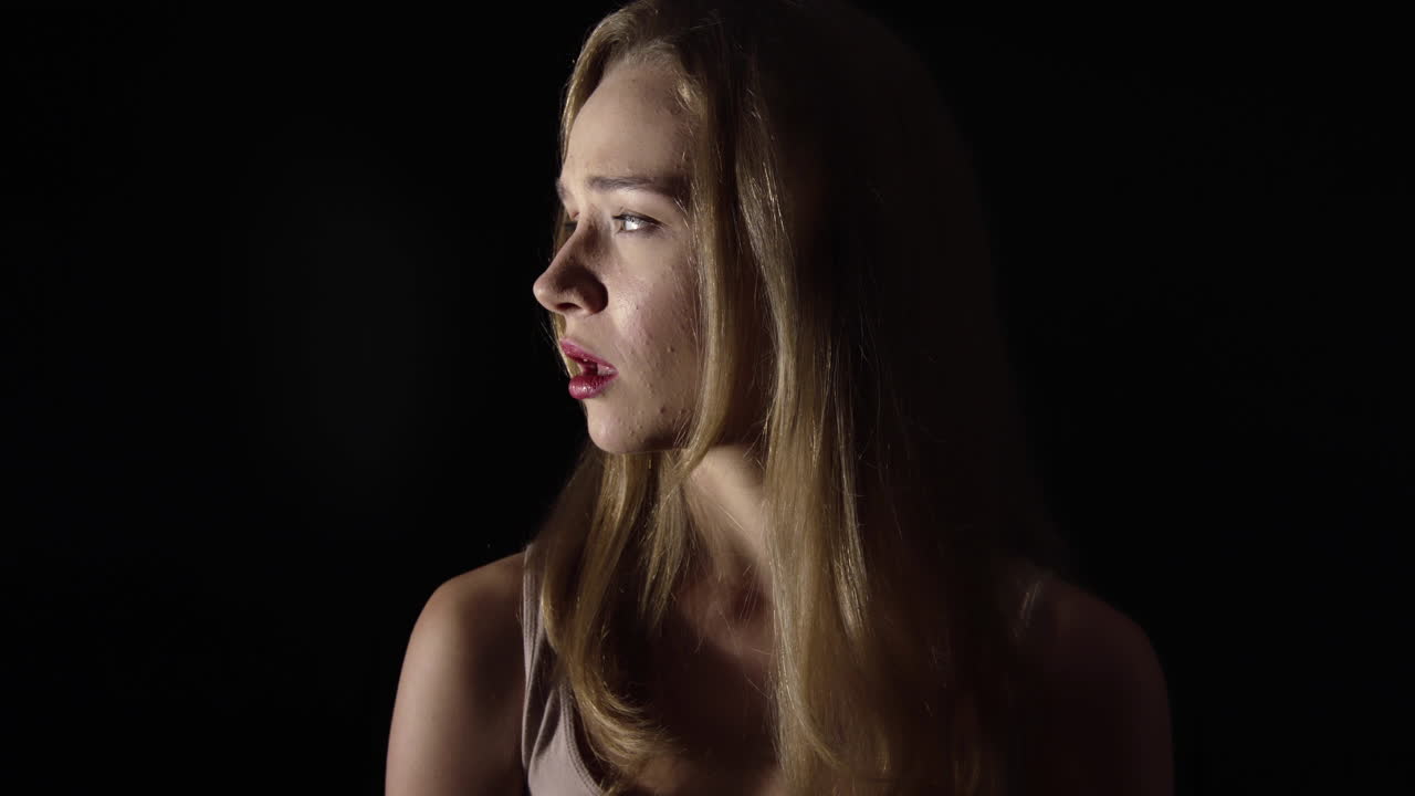 Kidnap victim, scared girl with a gun barrel at her temple