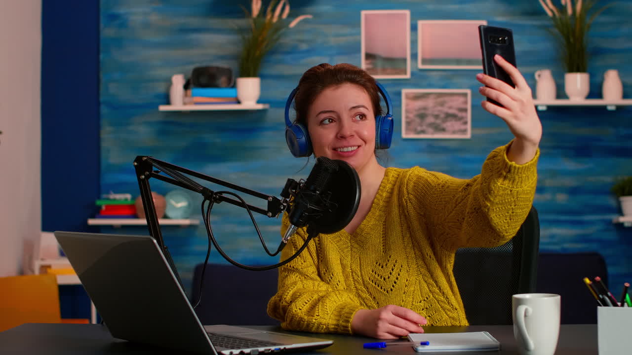 Entertainment podcaster taking selfie during broadcast