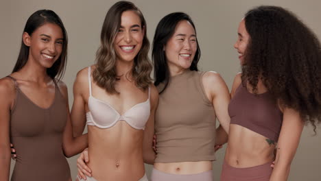 four diverse women smiling together