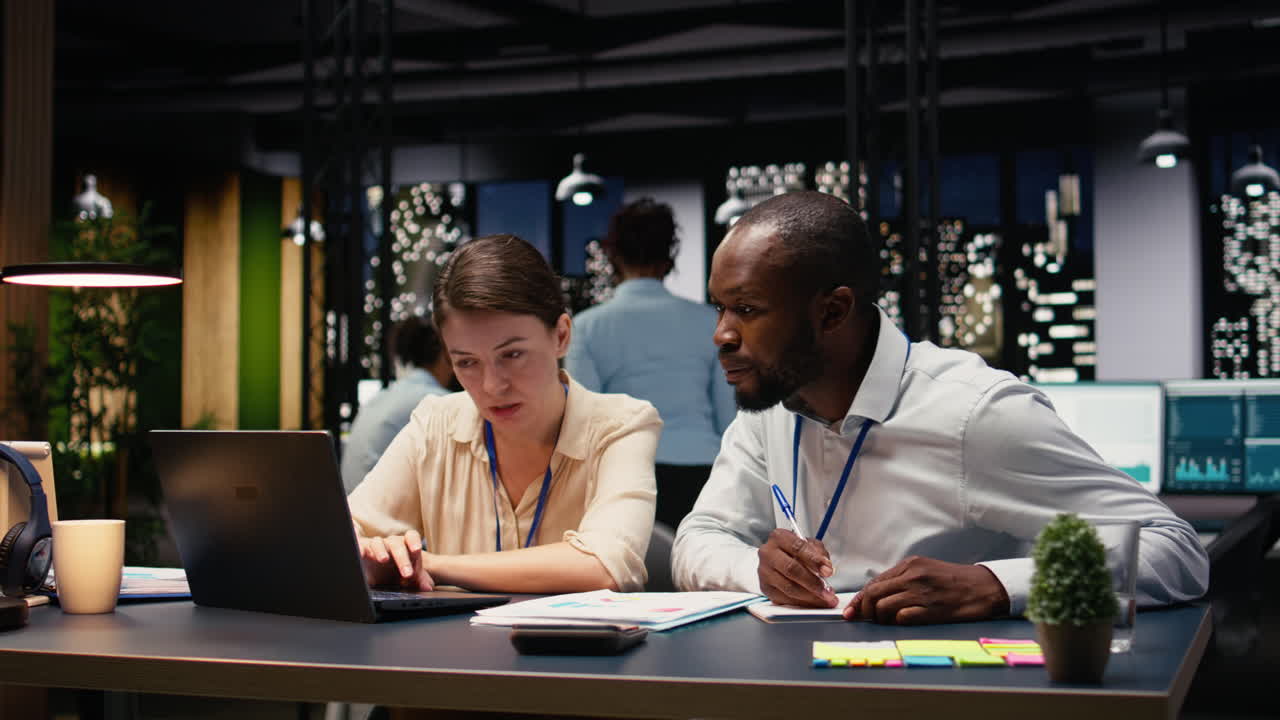 Diverse business team working together in office late at night