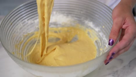 Close-Up-view-of-female-hands-mixing-ingredients-using-whisk-to-prepare-dough-in-the-kitchen.-Homemade-food.-Slow-Motion-shot