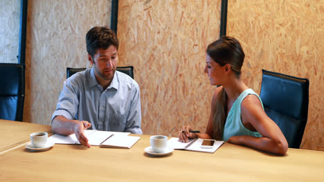 businesswoman having a discussion with coworker