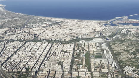 aerial side view of valencia city center, with a view of the harbor and the north coast in a summer morning. 4k