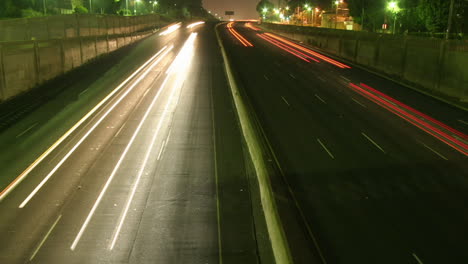 traffic drives along a freeway at night