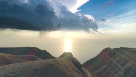 the four people standing on the mountain cliff against the seascape. hyperlaps