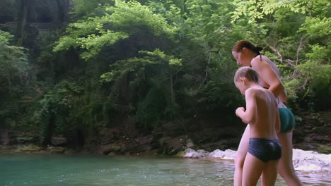 mother and son enjoying a day by the creek