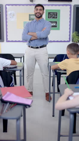 vertical video: in school, teacher stands confidently in front of class