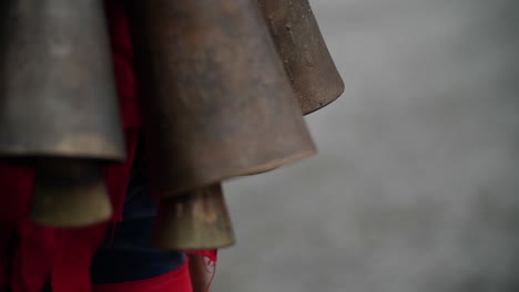 slow motion bouncing of bells part of red bulgarian kuker costume during a traditional dance symbolically to scare the forest ghosts