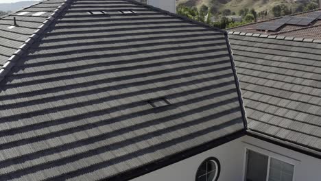 Aerial-closeup-inspecting-of-home-roof,-wood-shingles-exterior