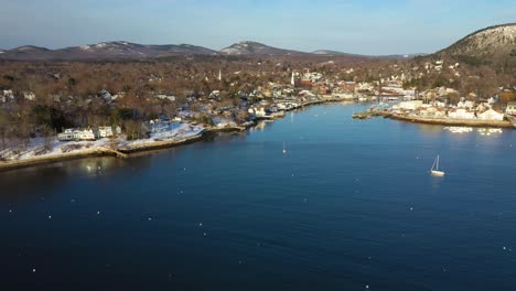 aerial footage flying towards a quiet camden harbor on a cold winter morning