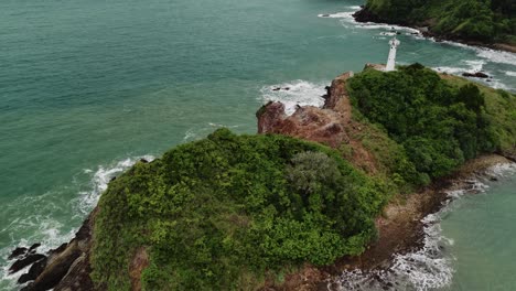 aerial drone footage of island with lighthouse off the coast of lanta