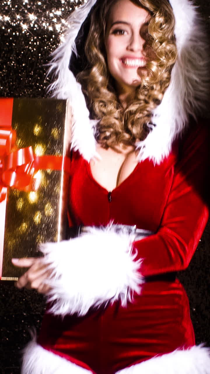 크리스마스 시간 디스코 촬영을 위해 사랑스러운 산타클로스 의상을 입은 여성이 춤을 춘다