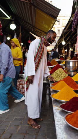 man browsing spices in a bustling market