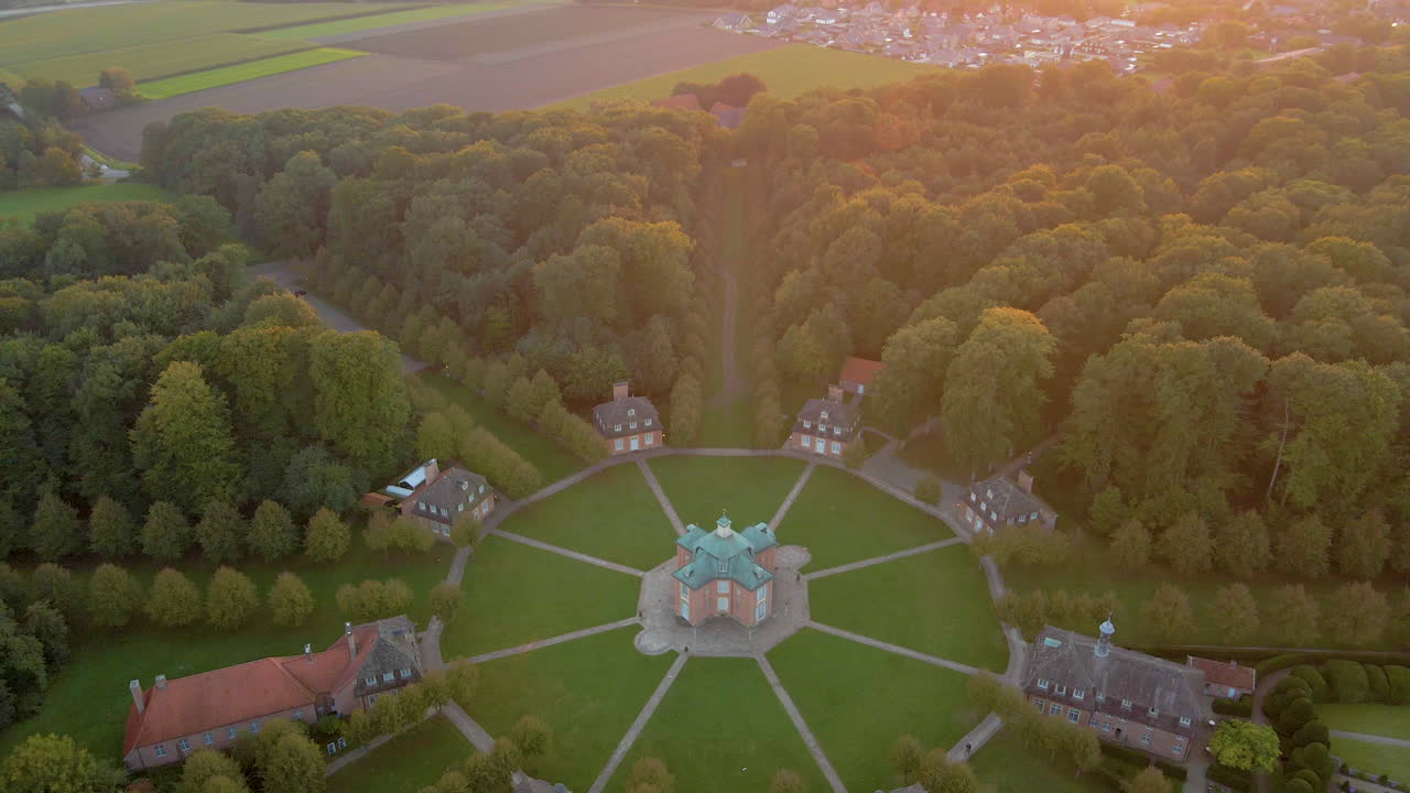Aerial View Of Clemenswerth Palace And Clemenswerther Park In Sogel, Germany. - tilt up