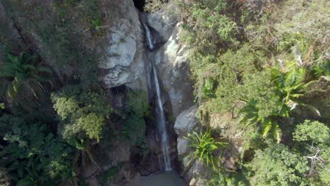 cascada de yelapa flowing from sheer rock mountains amidst tropical forest in jalisco, mexico