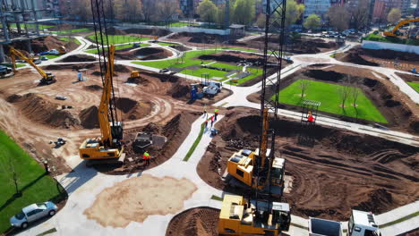 construction of a park with heavy machinery and workers