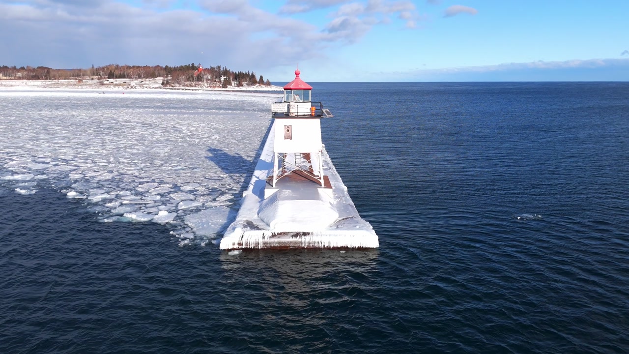 Light house in Two Harbors Minnesota during a winter cold day in Lake Superior with ice formations