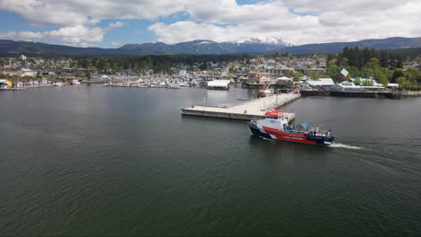 skimming vessel patrolling across the waters of port alberni in british columbia, canada