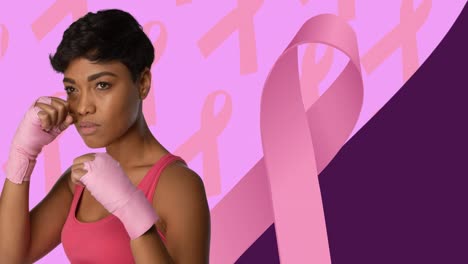 Animation-of-pink-ribbon-with-mixed-race-woman-boxing