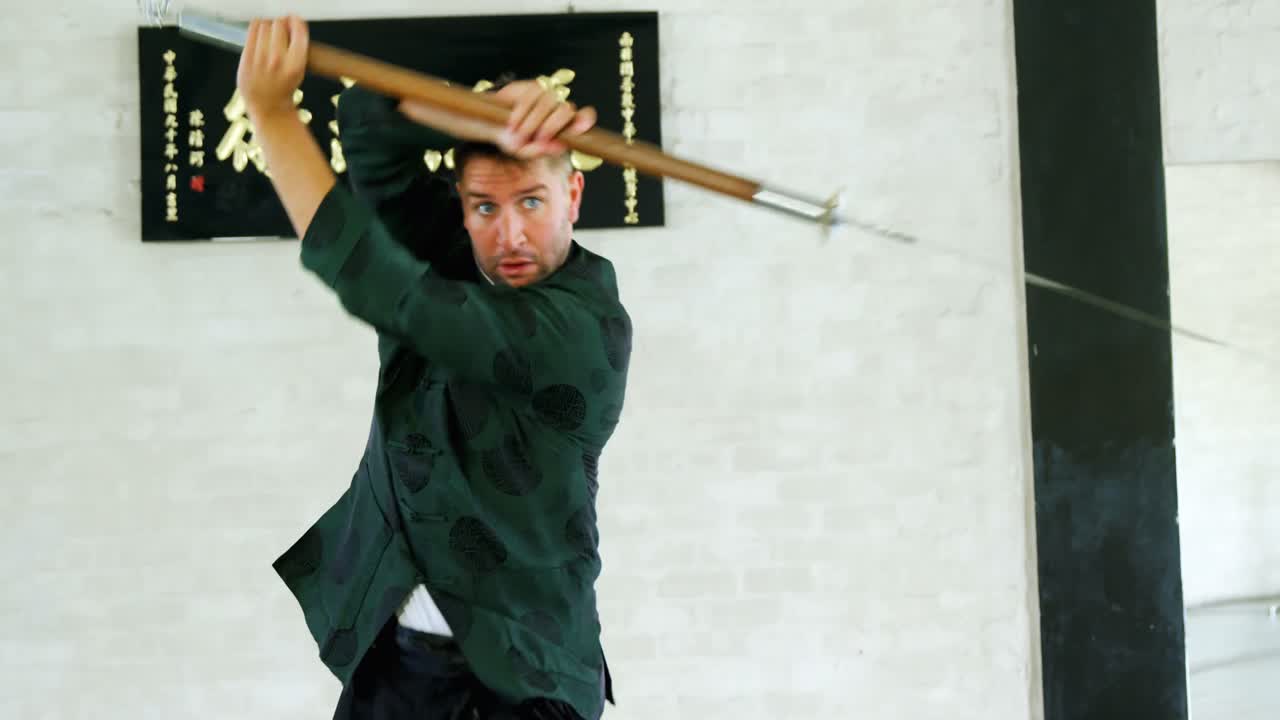 Kung fu fighter practicing martial arts with sword 4k