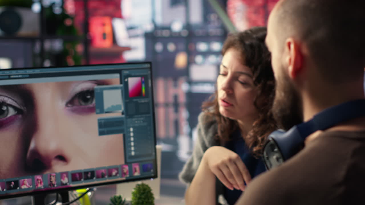 Graphic designer and photographer collaborate in a modern studio