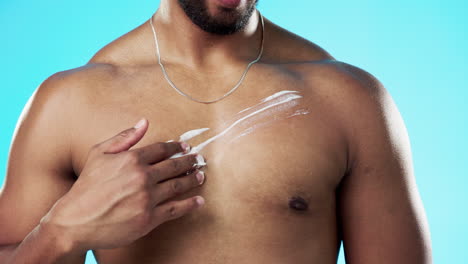 man applying sunscreen to chest