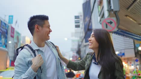 asian attractive romantic couple travel in the city for honeymoon trip. young new marriage man and woman backpacker tourist use map find destination and enjoy spend time on holiday vacation together.