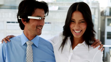 business partners smiling at camera together with smart glasses